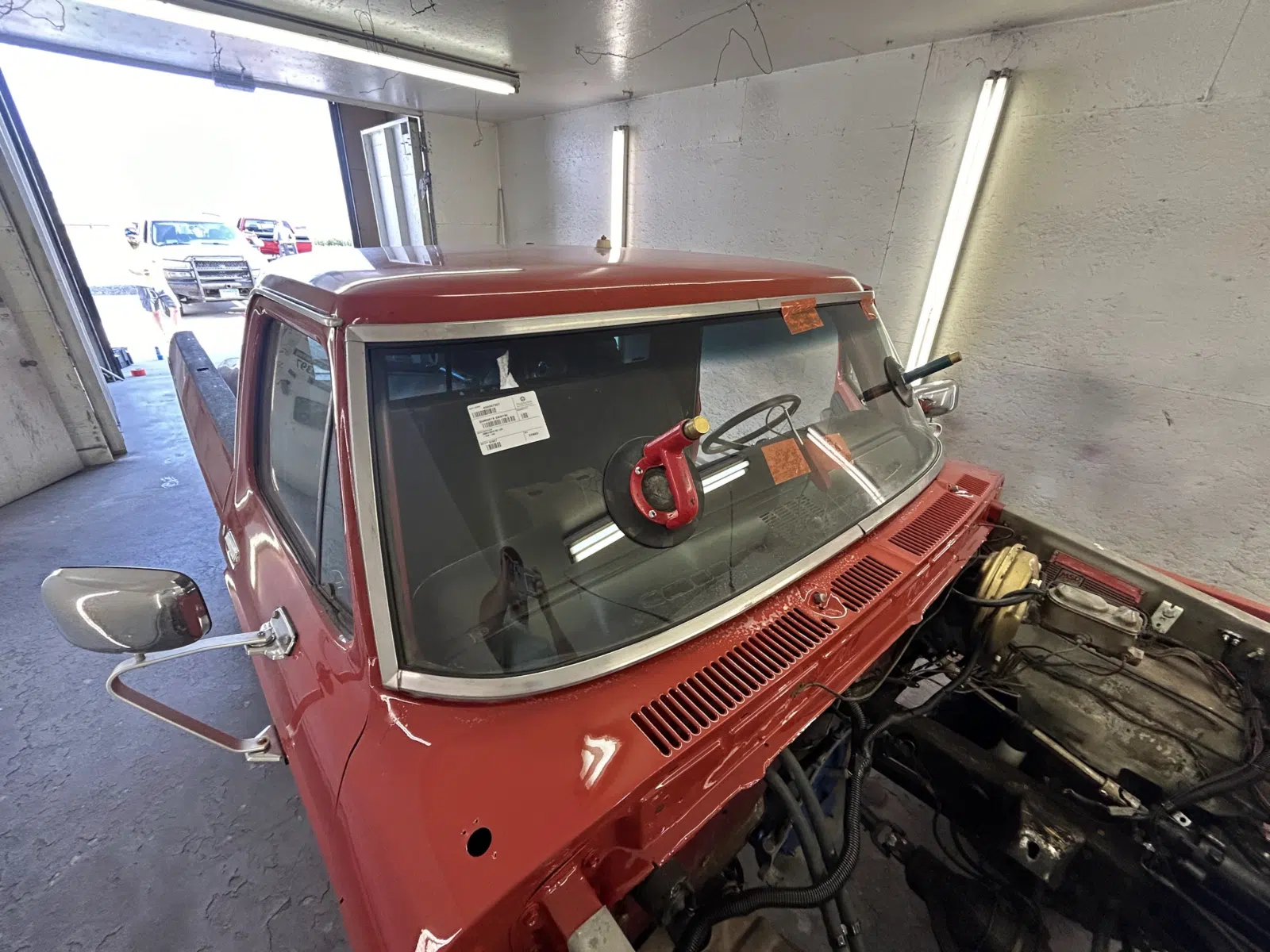 Suction cup holding new windshield on a red classic truck — A+ Glass LLC in Billings