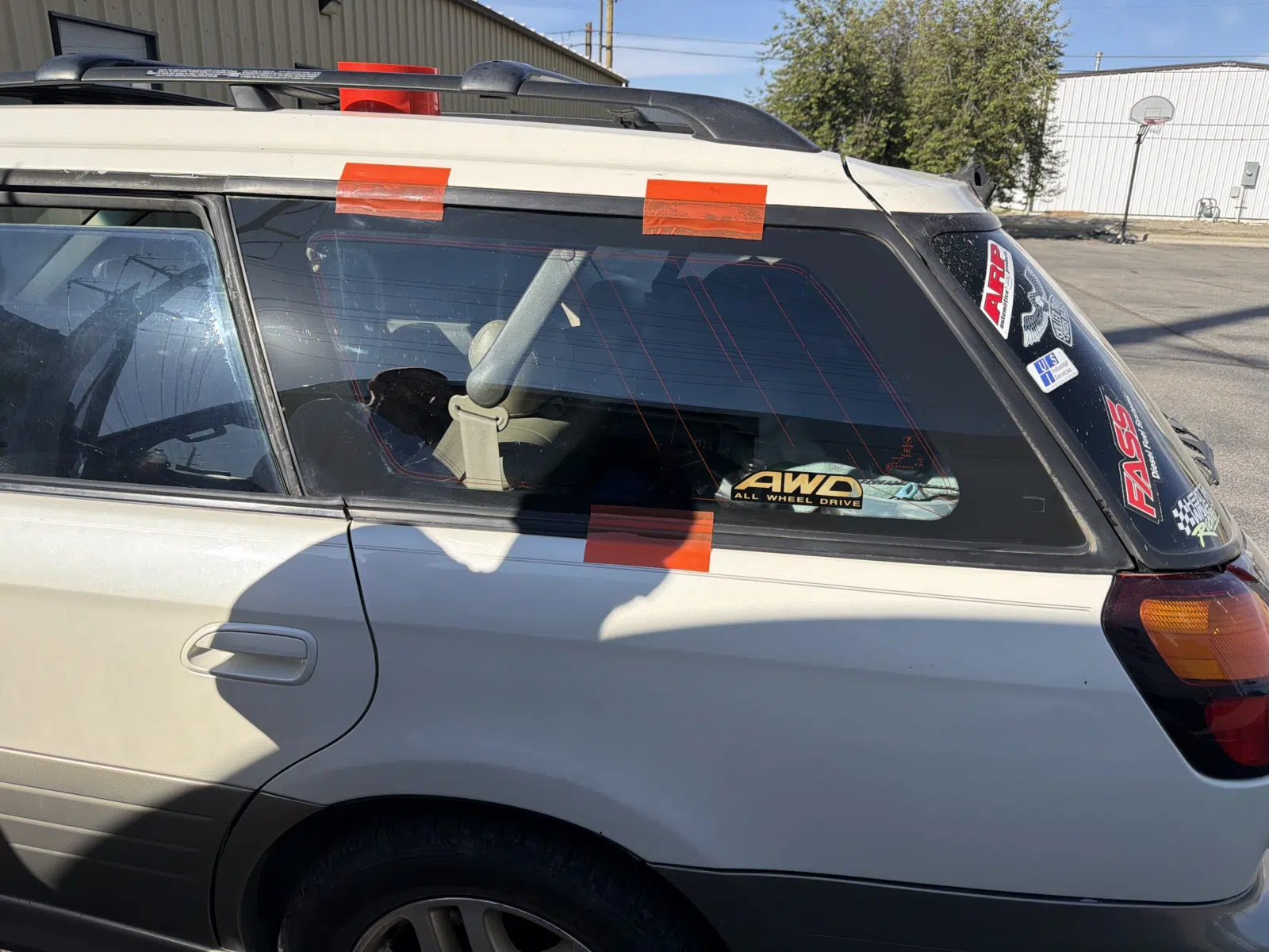 Taped rear quarter window on a silver station wagon — A+ Glass LLC in Billings